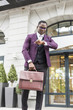 © xartproduction - stylish businesswoman with briefcase on city background. African American man talking on mobile phone