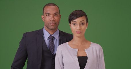 African American business professionals pose for a portrait on green screen