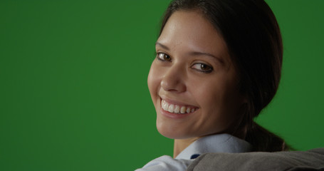 Wall Mural - Pretty brunette woman looking back and smiling at camera on greenscreen