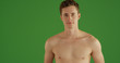 Closeup of handsome young shirtless white man on green screen