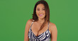 © rocketclips - Portrait of beautiful Latina female smiling in dress on green screen