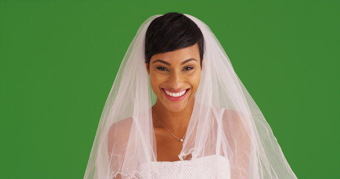 Wall Mural -  - Closeup of happy bride in wedding dress smiling at camera on green screen