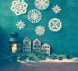 Wall Mural - a new Year and Christmas  composition with lantern , wooden houses,figures of angel and birds and with spruce twigs with cones