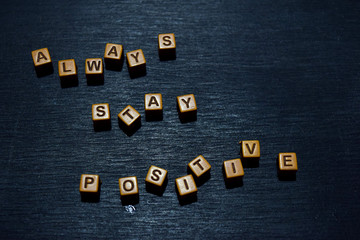 always stay positive message written on wooden blocks. motivation concepts. cross processed image