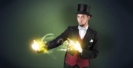 Magician holding his sparkling power between his two hand