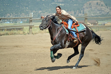 Cowgirl Looks at Stop Clock While Galloping