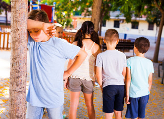 Wall Mural - playing hide and seek. boy closed eyes his hands