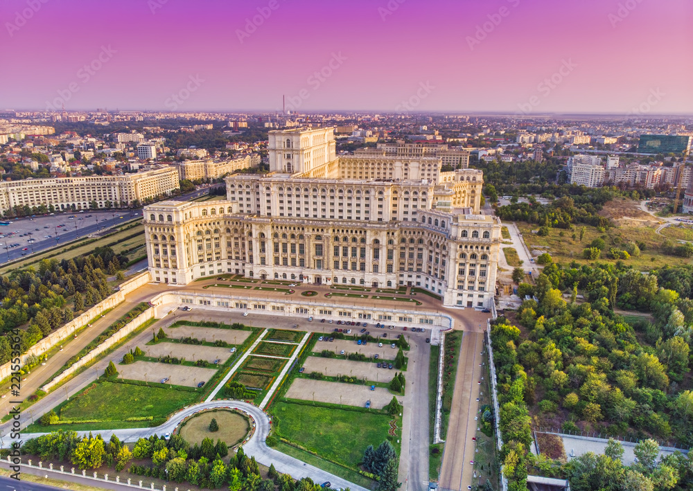 Obraz na płótnie Parliament building or People's House in Bucharest city. Aerial view at sunset with abstract pink sky w salonie