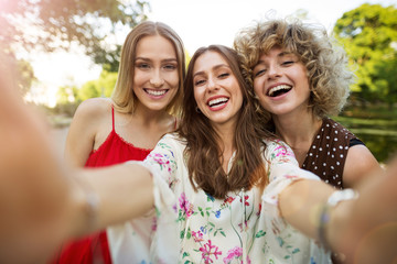 Wall Mural - three friends taking selfies
