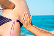 © andov - A man is holding a pregnant woman by the stomach on the beach, by the sea. The concept of family, love, new life and peace, the expectation of the child.