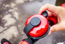 Child Hand Ringing Bicycle Bell Outside.