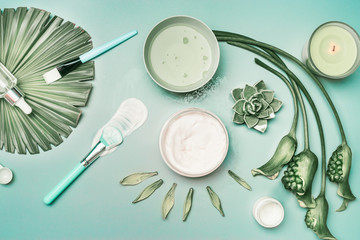 Wall Mural - natural cosmetic and tools for home facial skin care with flowers and green tropical leaves, top vie