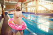© Studio Romantic - A funny fat man with a beard swims in the swimming pool.