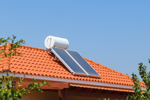 Solar Water Heating Panel And Water Collector On A House Roof.