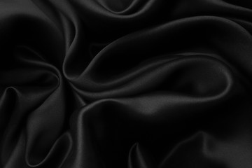 elegant black satin silk with waves, abstract background.