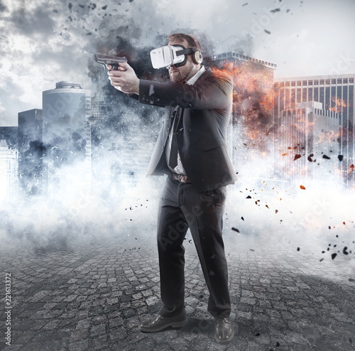 Foto Businessman is playing a game wearing virtual reality glasses and holding a gun