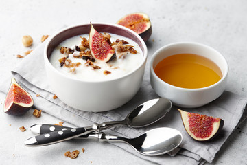 Wall Mural - Healthy breakfast concept. Homemade yoghurt with organic granola, nuts and fig fruits in small bowl.