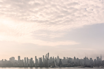 Fototapete - New York City midtown Manhattan skyline panorama view from Boulevard East Old Glory Park over Hudson River on a misty morning.