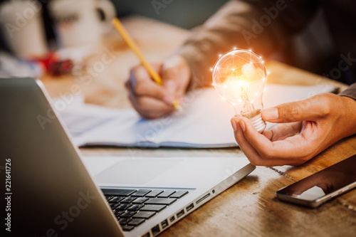 Cuadros en Lienzo business man accountant holding light bulb, new idea with innovation concept