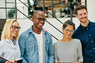 Smiling group of diverse businesspeople working together in an o