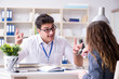 © Elnur - Sales assistant discussing transaction with customer