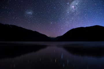 amazing starry night at lake rotoiti. reflection of the milky way and galaxy on the lake. nelson lak