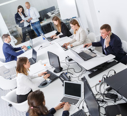 High-angle view of business people working and communicating together