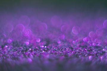 Wall Mural - Violet bokeh on a black background. Defocused. Abstract background for your design. Free space for text.