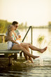 © BGStock72 - Romantic couple sitting on the wooden pier on the lake