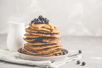 Canvas Print - Stack vegan blueberry pancakes with peanut butter and syrup.