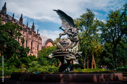 Fotografie, Obraz NEW YORK: statue near St.John cathedral the "Peace fountain"