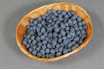 Wall Mural - Several ripe sloe berries in a basket in the kitchen 