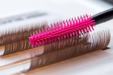 Eyelash brown extension procedure. Set Lashes close up pink comb