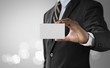 © Costello77 - Business solution, strategy or success concept. Businessman is holding a paper card with blank space for input any text, word or message on bright tone background.