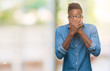© Krakenimages.com - Young african american man over isolated background shocked covering mouth with hands for mistake. Secret concept.
