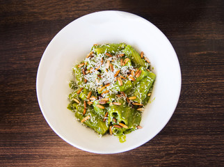 Wall Mural - Pesto pasta on a plate top view