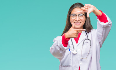 Young arab doctor woman over isolated background smiling making frame with hands and fingers with happy face. Creativity and photography concept.