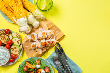 Summer bbq party concept - grilled chicken, vegetables, corn, salad, top view, copy space