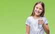 © Krakenimages.com - Young beautiful girl drinking glass of water over isolated background with a happy face standing and smiling with a confident smile showing teeth