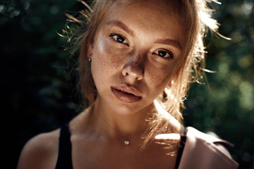 portrait of cute beautiful young girl with freckles close-up