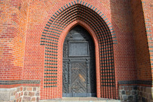 Old Gothic Medieval Door On Brick Wall Of Church  