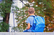 © vejaa - Boy with backpack sitting after school outdoors
