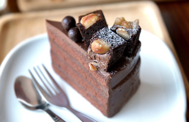 Chocolate cake on dish at coffeeshop table