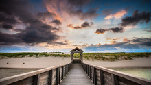 Architecture And Art Along The Dutch Coast With Beautiful Sunset And Threatening Clouds Along The Beach And The Dunes