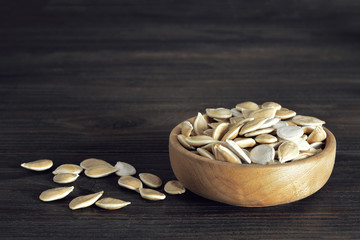 Wall Mural - Pumpkin seeds in wooden bowl