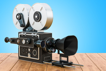 Poster - Old movie camera on the wooden table. 3D rendering