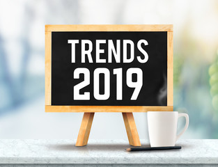 Aufkleber - Trends 2019 on blackboard with easel on marble table with sun and blur green tree bokeh background.business vision concept.