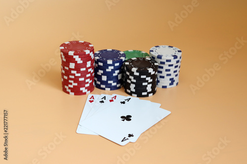 фотография The pile of casino chips and four A cards.