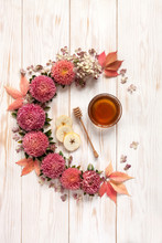 Apples, Pink Flowers And  Honey With Copy Space Form A Floral Decoration. Concept For Rosh Hashanah The Jewish New Year, Harvest Festival, Lammas. Top View, Close Up On White Wooden Background.
