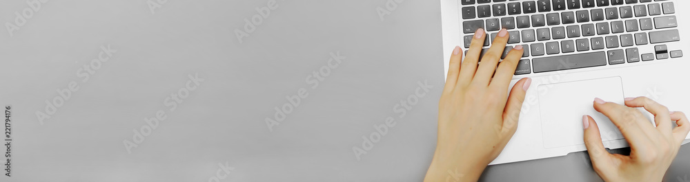 Website banner of top view laptop keyboard and female hands with copyspace in grey color background. Concept of blog header and copywriter occupation, business. - obrazy, fototapety, plakaty 